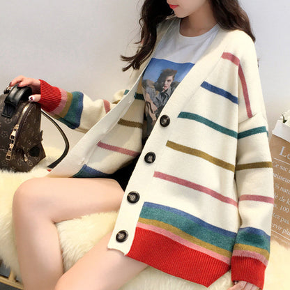 Stylish women's rainbow striped sweater cardigan, offering a cozy and trendy look. 