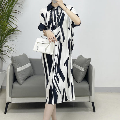     Stylish women's pleated cardigan dress with a casual printed design.     